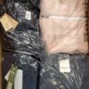 The photo shows a package with clothing in the category AJW.