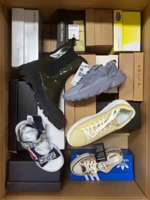 The photo shows a package with footwear in the category AS.