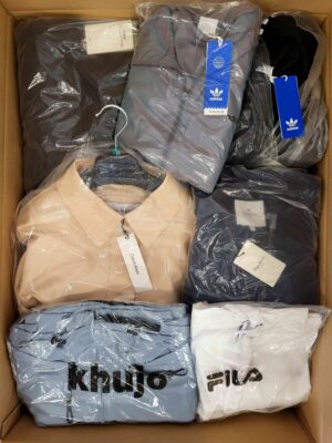 The photo shows a package with clothing in the category AJS.