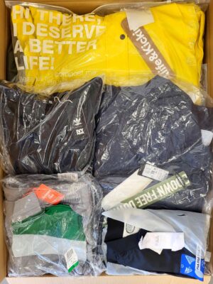 The photo shows a package with clothing in the category AJS.