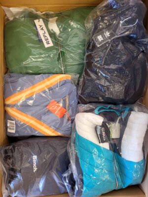 The photo shows a package with clothing in the category AJS.