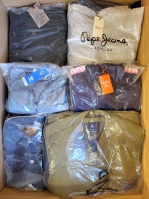The photo shows a package with clothing in the category AJS.
