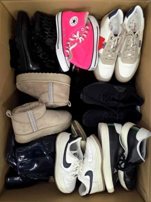 The photo shows a package with footwear in the category SH.