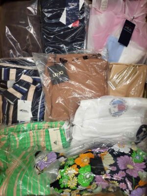 The photo shows a package with clothing in the category AW.