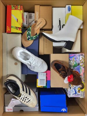 The photo shows a package with footwear in the category AS.