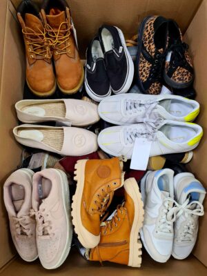 The photo shows a package with footwear in the category SH.