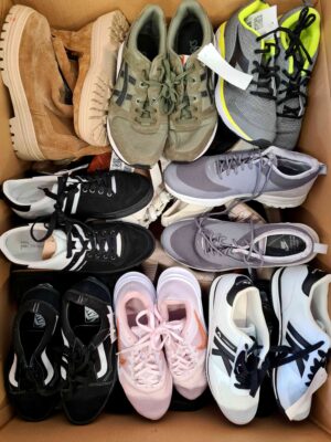 The photo shows a package with footwear in the category SH.