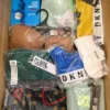 The photo shows a package with clothing in the category AU.