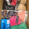 The photo shows a package with clothing in the category AU.