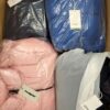 The photo shows a package with clothing in the category AJW.