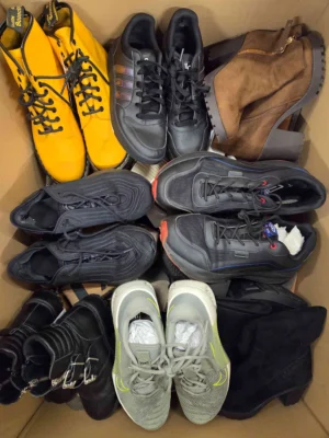 The photo shows a package with footwear in the category SH.