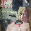 The photo shows a package with clothing in the category AW.