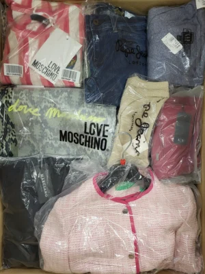 The photo shows a package with clothing in the category AW.