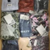 The photo shows a package with clothing in the category AW.