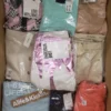The photo shows a package with clothing in the category AW.