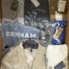 The photo shows a package with clothing in the category AM.