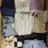 The photo shows a package with clothing in the category TSC.