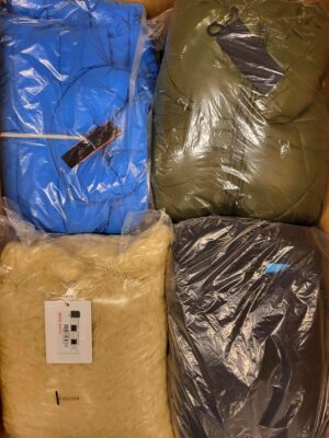 The photo shows a package with clothing in the category AJW.