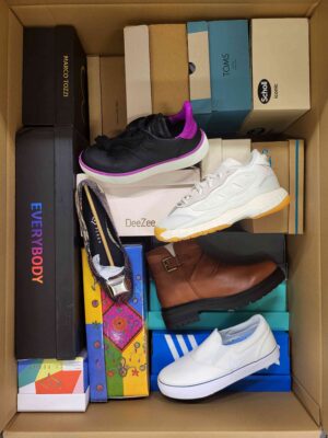 The photo shows a package with footwear in the category AS.