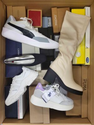 The photo shows a package with footwear in the category AS.