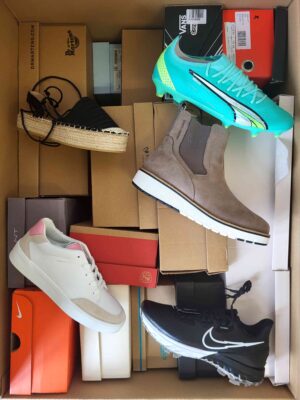 The photo shows a package with footwear in the category AS.