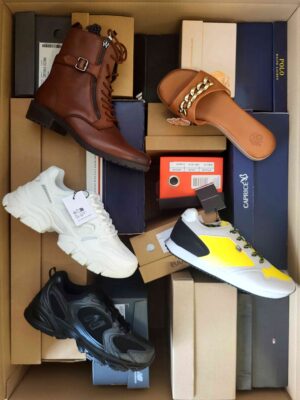 The photo shows a package with footwear in the category AS.