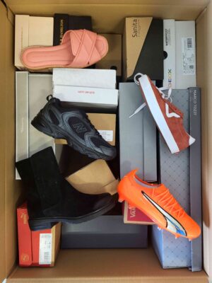 The photo shows a package with footwear in the category AS.
