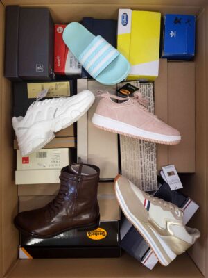 The photo shows a package with footwear in the category AS.