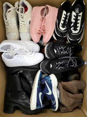 The photo shows a package with footwear in the category SH.