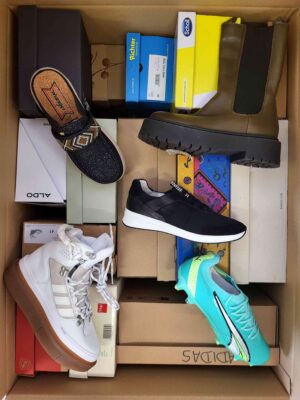 The photo shows a package with footwear in the category AS.