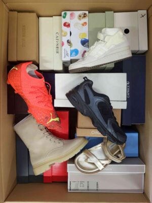 The photo shows a package with footwear in the category AS.