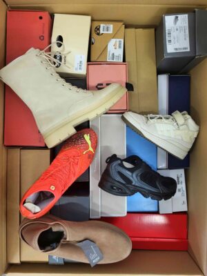 The photo shows a package with footwear in the category AS.