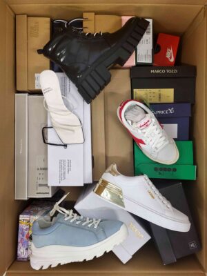 The photo shows a package with footwear in the category AS.