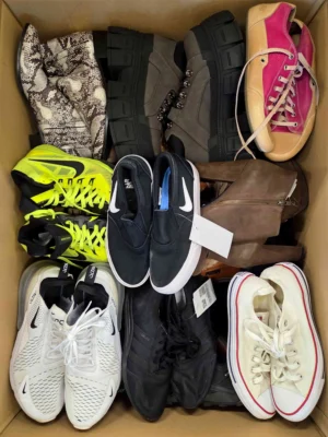 The photo shows a package with footwear in the category SH.