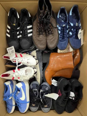 The photo shows a package with footwear in the category SH.