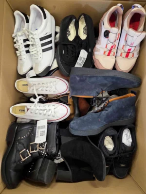 The photo shows a package with footwear in the category SH.