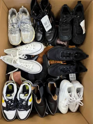 The photo shows a package with footwear in the category SH.