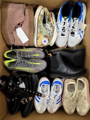 The photo shows a package with footwear in the category SH.