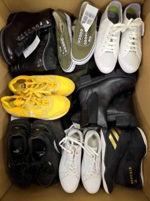 The photo shows a package with footwear in the category SH.