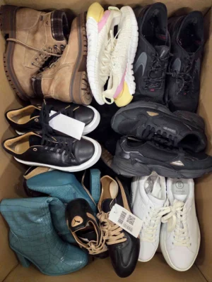 The photo shows a package with footwear in the category SH.