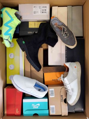 The photo shows a package with footwear in the category AS.