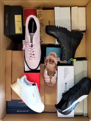 The photo shows a package with footwear in the category AS.