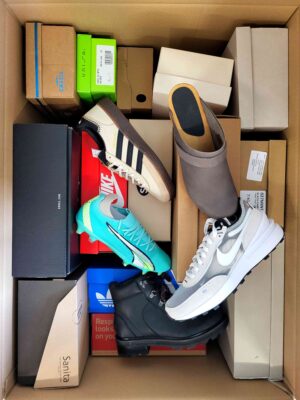 The photo shows a package with footwear in the category AS.