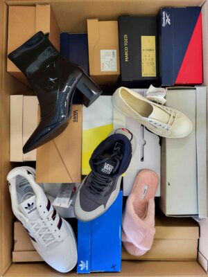 The photo shows a package with footwear in the category AS.