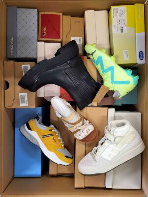 The photo shows a package with footwear in the category AS.