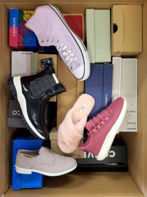 The photo shows a package with footwear in the category AS.