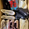 The photo shows a package with footwear in the category SH.