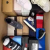 The photo shows a package with footwear in the category AS.
