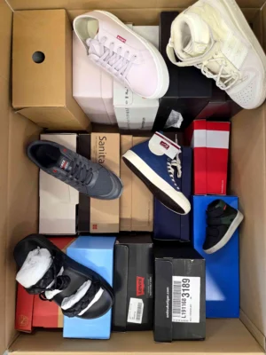 The photo shows a package with footwear in the category AS.