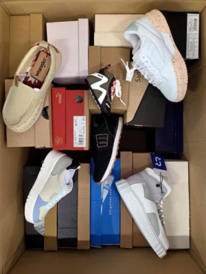 The photo shows a package with footwear in the category AS.